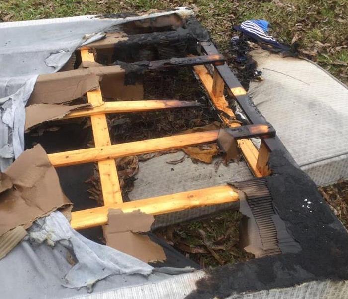 Burned mattress out in front yard