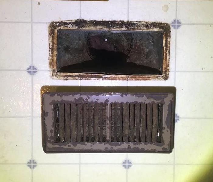 Heating and AC Floor Vent that is covered with soot from a kitchen fire