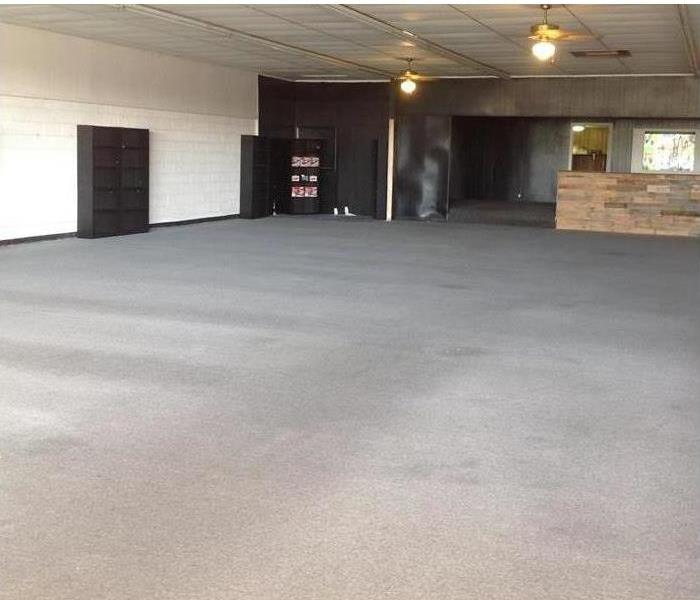 Large empty commercial building with grey carpet