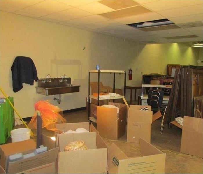 Large classroom with boxes packed and contents being prepared to pack out after a fire