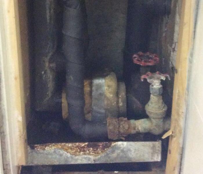 Water supply cabinet that has a broken pipe in an housing complex where the pipe caused flooding 