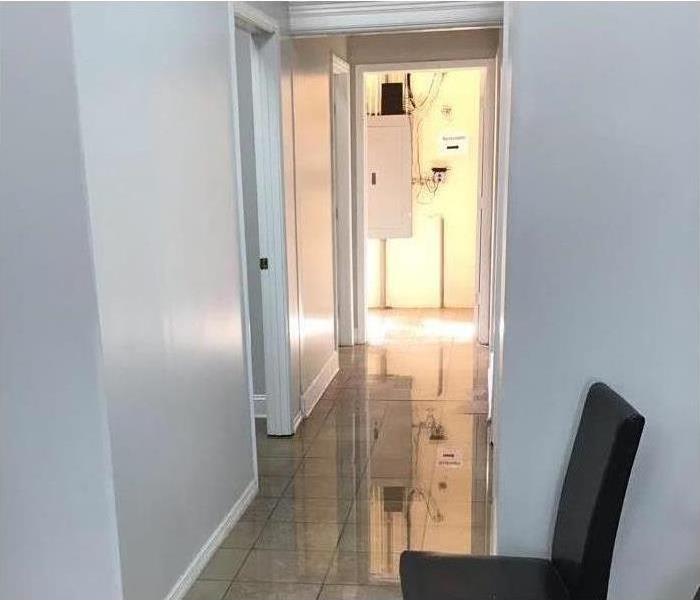 Hallway flooded in a nail salon due to a ruptured pipe