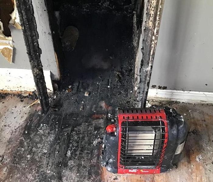Burned entrance to a room and burned space heater