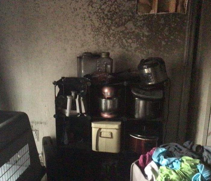 Kitchen stove and wall behind stove is burned